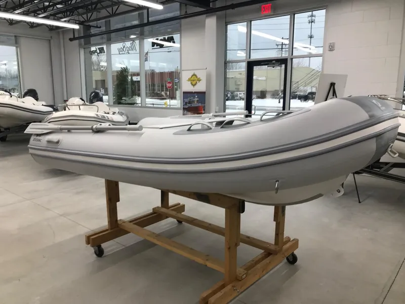 Slide: The Image of 2023 Zodiac Cadet 300 RIB ALU PVC boat displayed in showroom. - 1