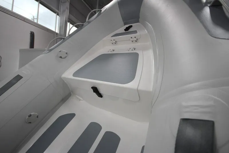 Slide: The Image of 2023 Zodiac Cadet 330 DL RIB ALU PVC interior view, showcasing seating and storage. - 2