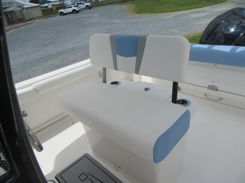 Slide: The Image of 2023 Robalo R222 Center Console boat seating area with white and blue upholstery. - 14