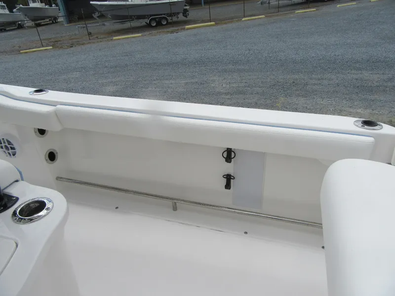 Slide: The Image of 2023 Robalo R222 Center Console boat interior, white seating and storage area. - 16