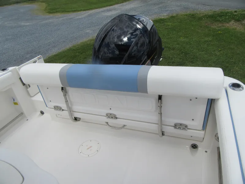 Slide: The Image of 2023 Robalo R222 Center Console boat with outboard motor and cushioned seating. - 18