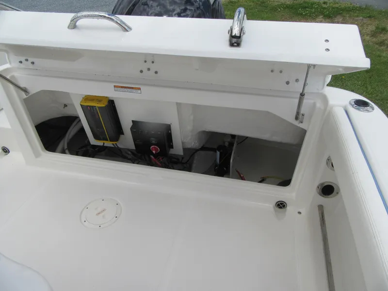 Slide: The Image of 2023 Robalo R222 Center Console boat storage compartment with open hatch. - 20