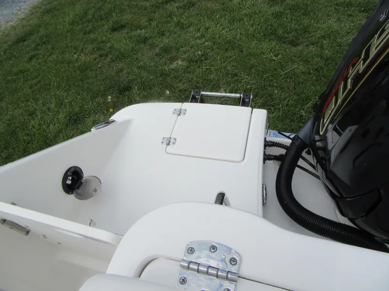 Slide: The Image of 2023 Robalo R222 Center Console boat stern with engine and storage compartment. - 23
