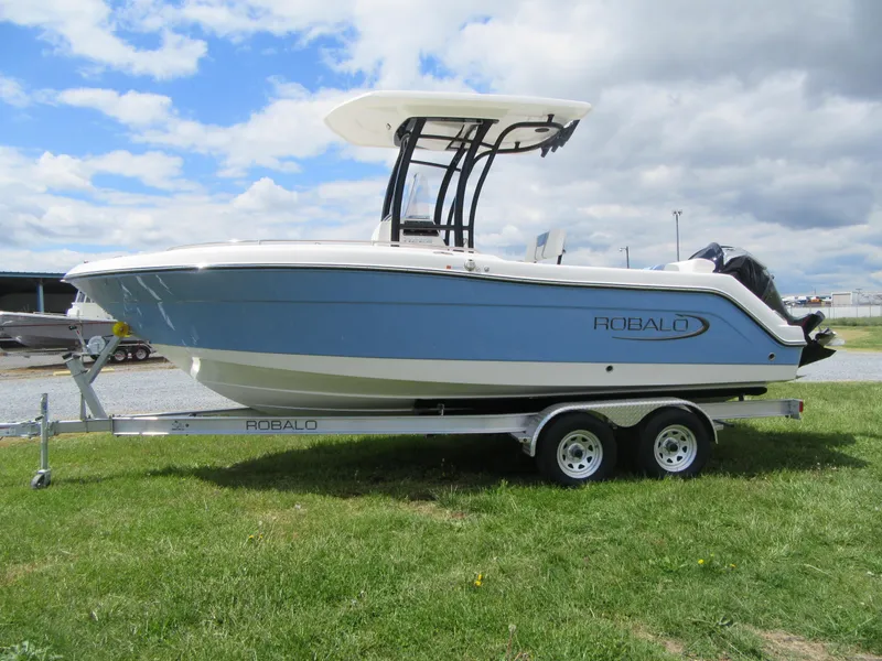 Slide: The Image of 2023 Robalo R222 Center Console boat on a trailer, side view. - 3