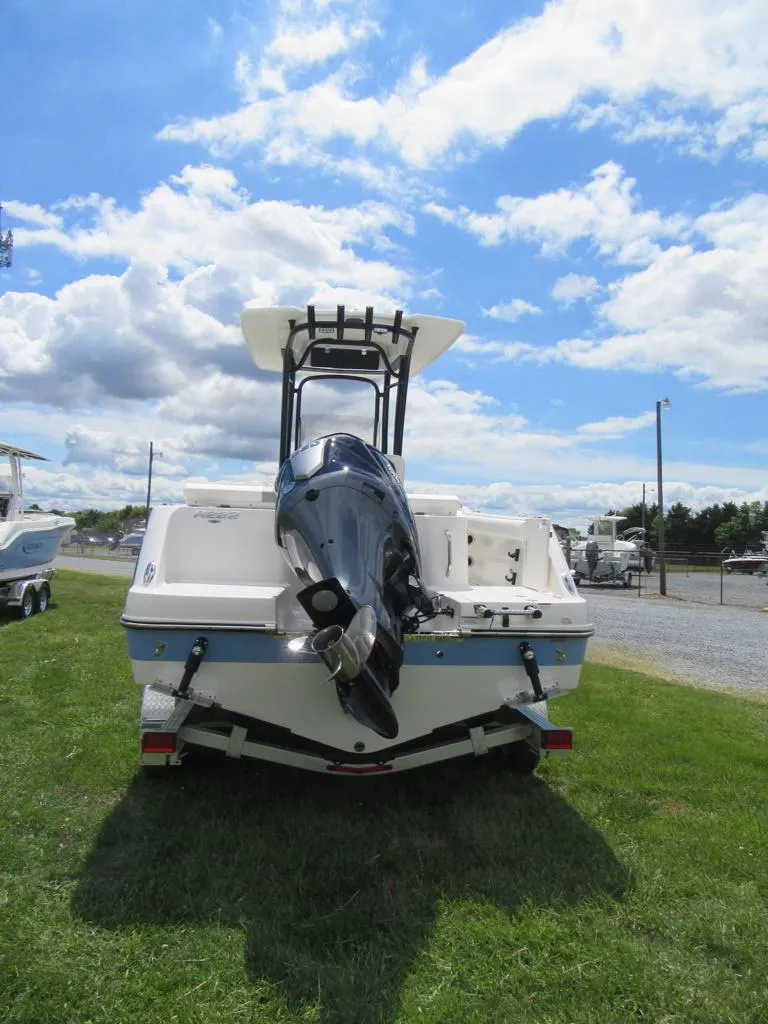 Slide: The Image of 2023 Robalo R222 Center Console boat on grass under a blue sky. - 4