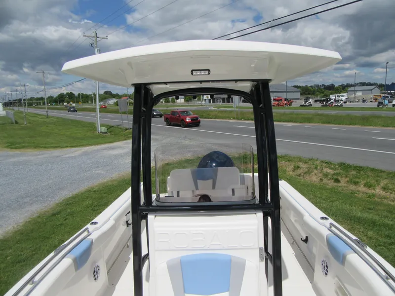 Slide: The Image of 2023 Robalo R222 Center Console boat on display near a road. - 7