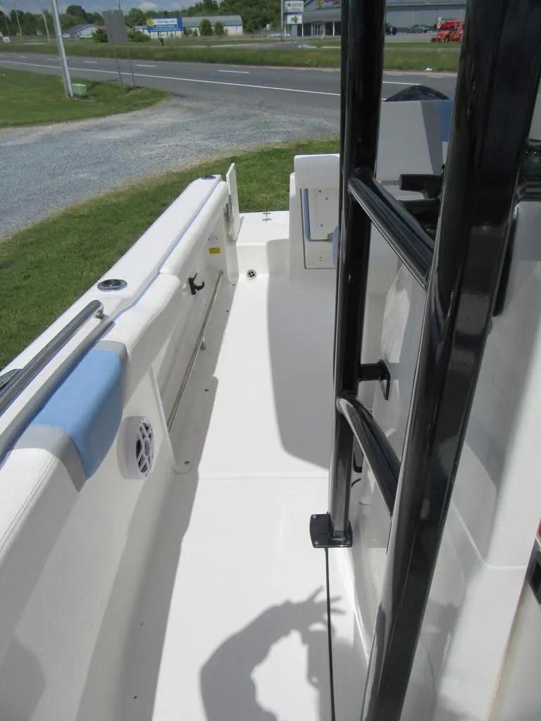 Slide: The Image of 2023 Robalo R222 Center Console boat interior with white deck and black railing. - 9