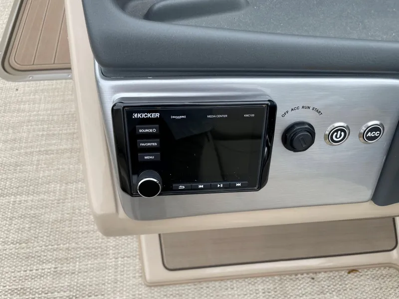 Slide: The Image of 2023 Regency 250 DL3 dashboard with Kicker audio system and control buttons. - 4