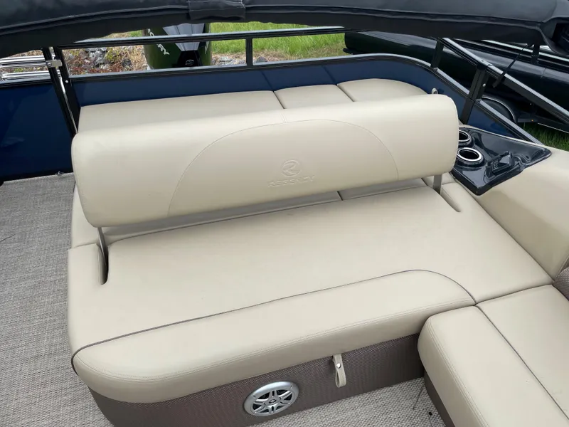 Slide: The Image of 2023 Regency 250 DL3 boat interior with beige seating and cup holders. - 8