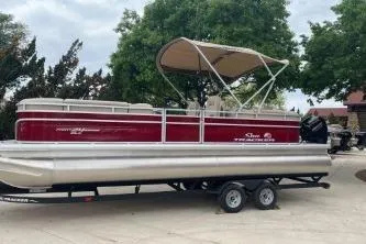 Slide: The Image of 2023 Sun Tracker Party Barge 22 RF XP3 pontoon boat on trailer, parked outdoors. - 9