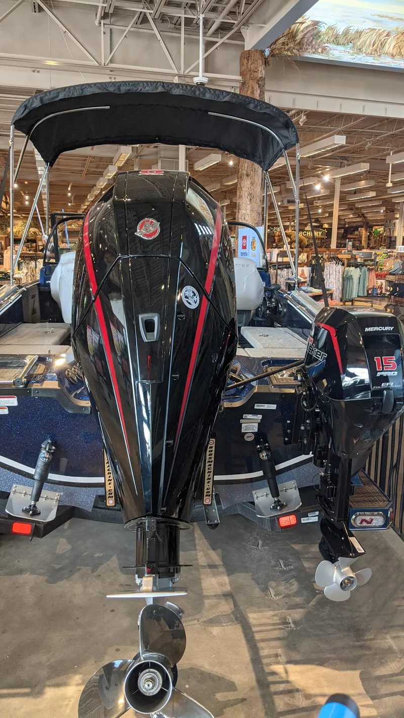 Slide: The Image of 2023 Nitro ZV20 Pro boat with dual outboard motors on display in a showroom. - 2