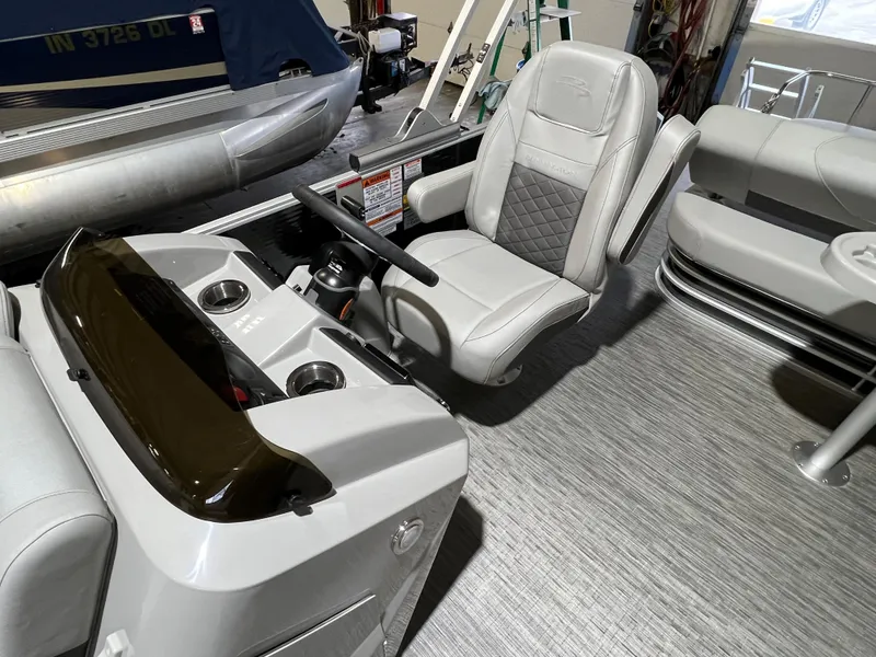 Slide: The Image of 2023 Bennington 22SXSB boat interior with steering console and seating. - 10