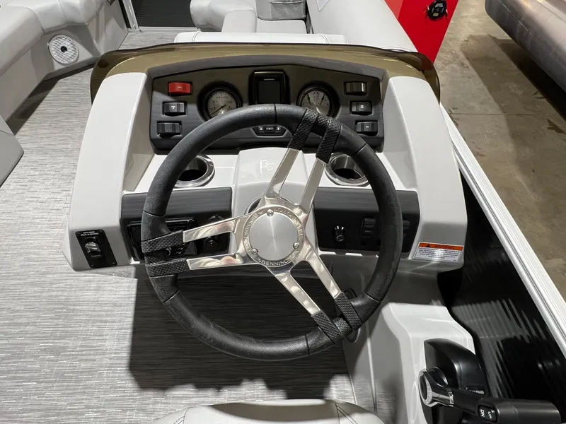 Slide: The Image of Steering console of 2023 Bennington 22SXSB boat with modern controls and gauges. - 11