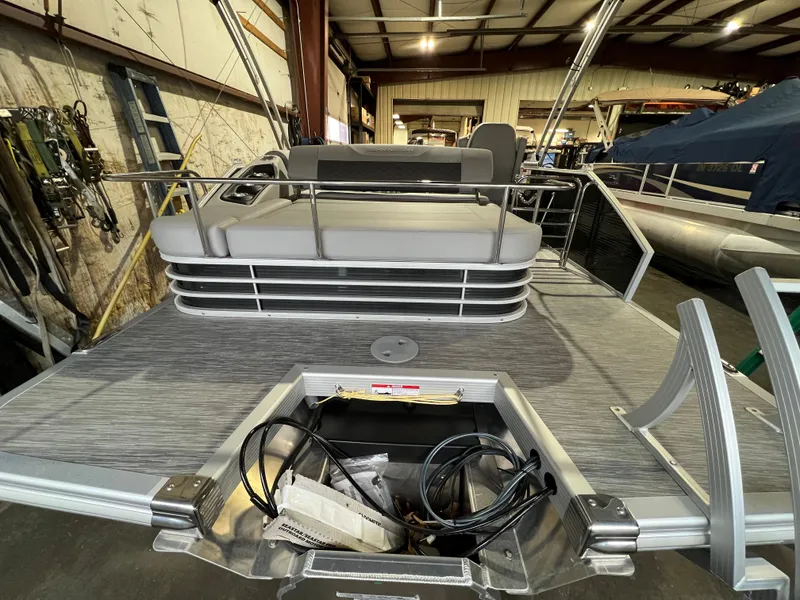 Slide: The Image of 2023 Bennington 22SXSB pontoon boat interior with open storage compartment. - 16