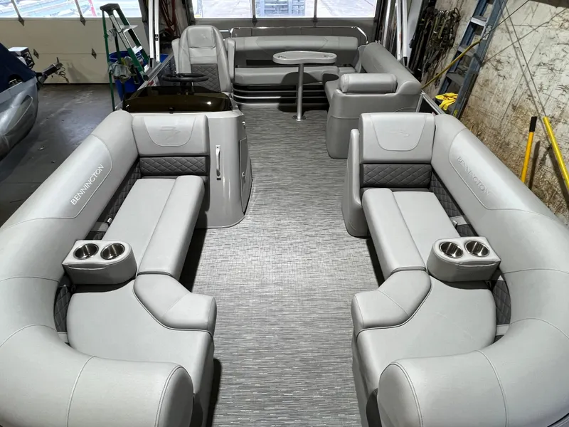 Slide: The Image of 2023 Bennington 22SXSB pontoon boat interior with gray seating and cup holders. - 7