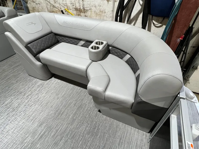 Slide: The Image of 2023 Bennington 22SXSB boat seating with gray upholstery and cup holders. - 9