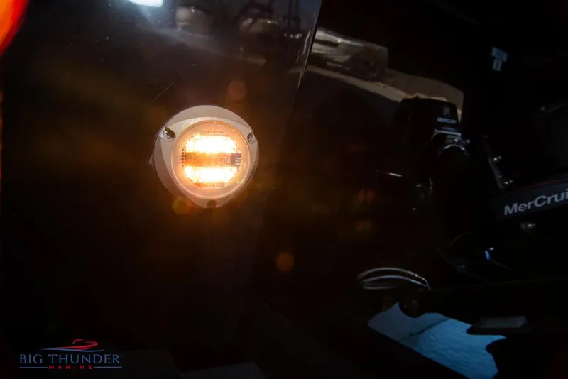 Slide: The Image of Close-up of a 2023 Monterey M6 boat's illuminated stern light and MerCruiser engine. - 14