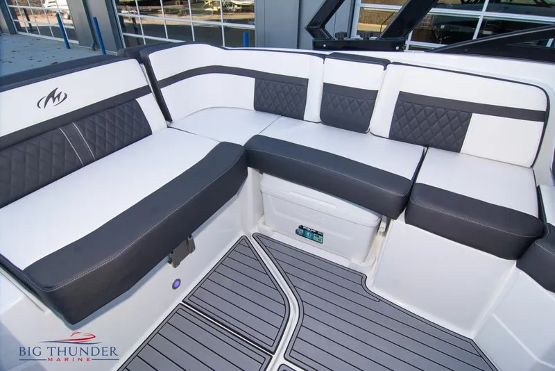 Slide: The Image of 2023 Monterey M6 boat interior with white and black cushioned seating. - 29