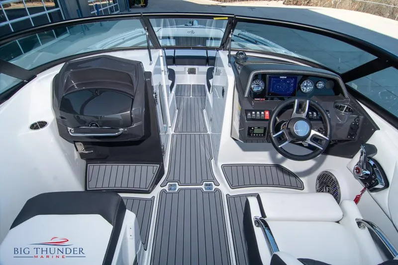 Slide: The Image of 2023 Monterey M6 boat interior with modern dashboard and seating, Big Thunder Marine logo. - 32