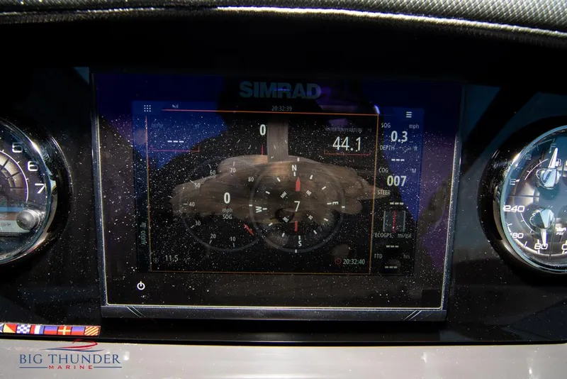 Slide: The Image of 2023 Monterey M6 boat dashboard with Simrad display and gauges. - 36