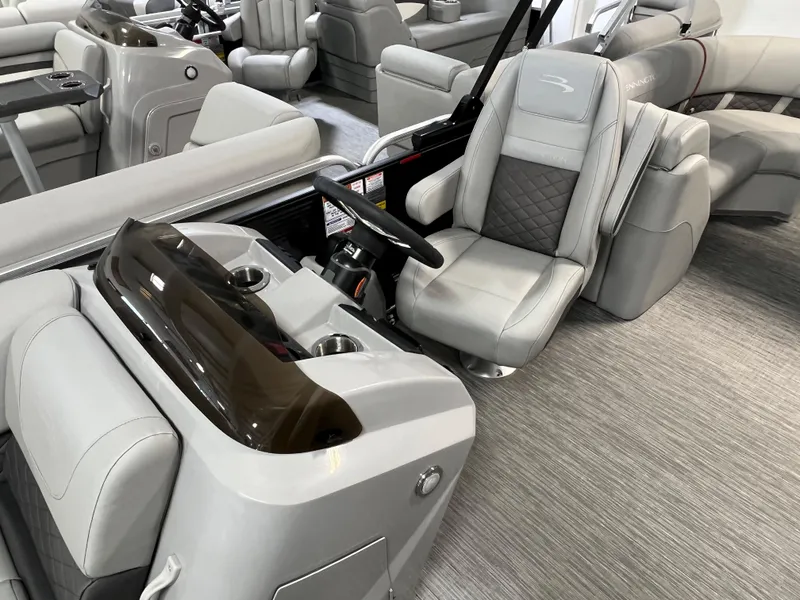 Slide: The Image of 2023 Bennington 22SXSRC boat interior with gray seating and modern helm. - 9