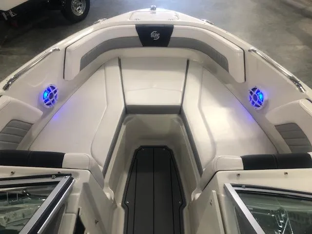 Slide: The Image of 2023 Chaparral 21 Surf boat interior with LED lights and cushioned seating. - 11