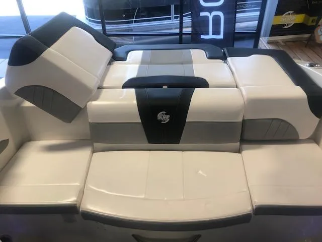 Slide: The Image of 2023 Chaparral 21 Surf boat interior seating, featuring sleek white and gray upholstery. - 7