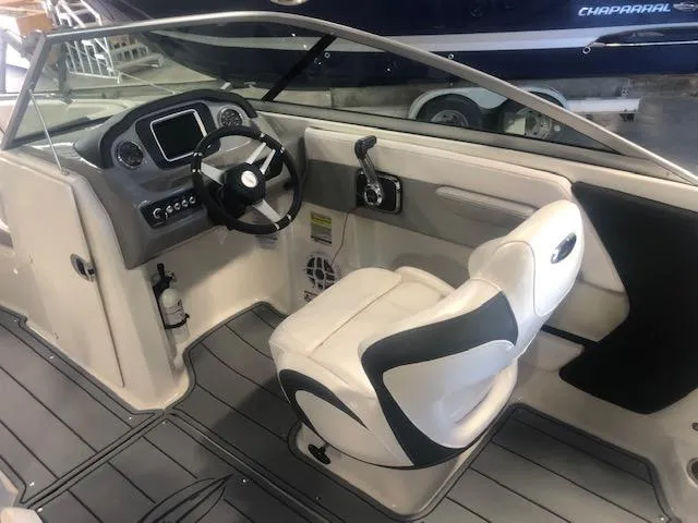 Slide: The Image of 2023 Chaparral 21 Surf boat interior with steering wheel and captain's seat. - 9