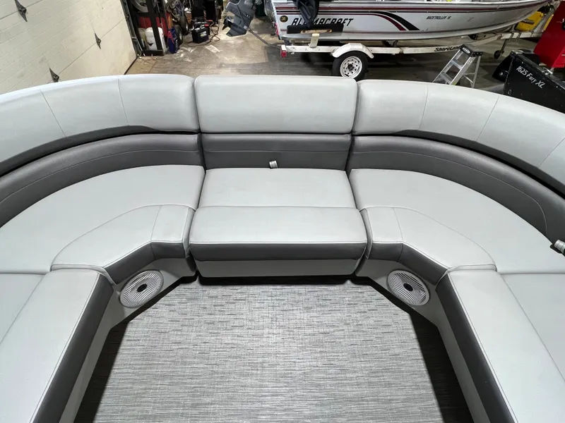 Slide: The Image of 2023 Bennington 22SXSB boat interior with gray seating and integrated speakers. - 4