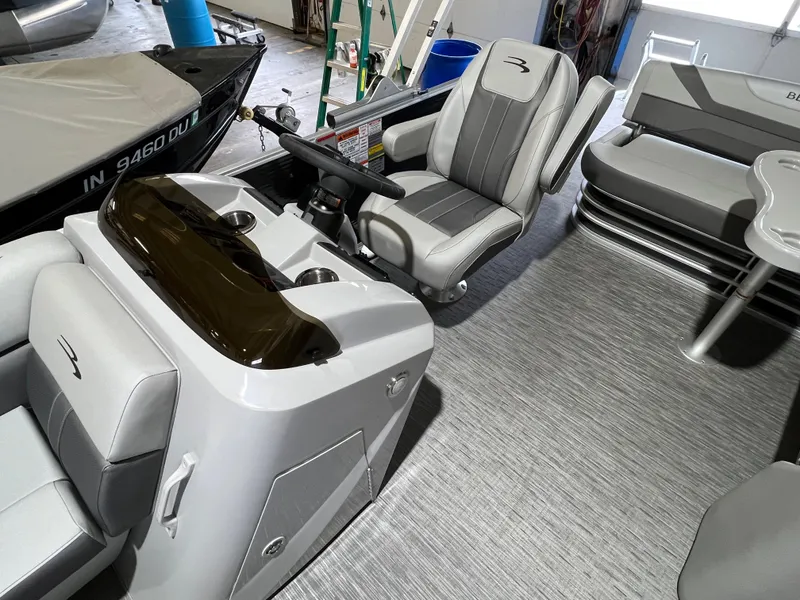 Slide: The Image of 2023 Bennington 22SXSB boat interior with modern seating and steering console. - 6