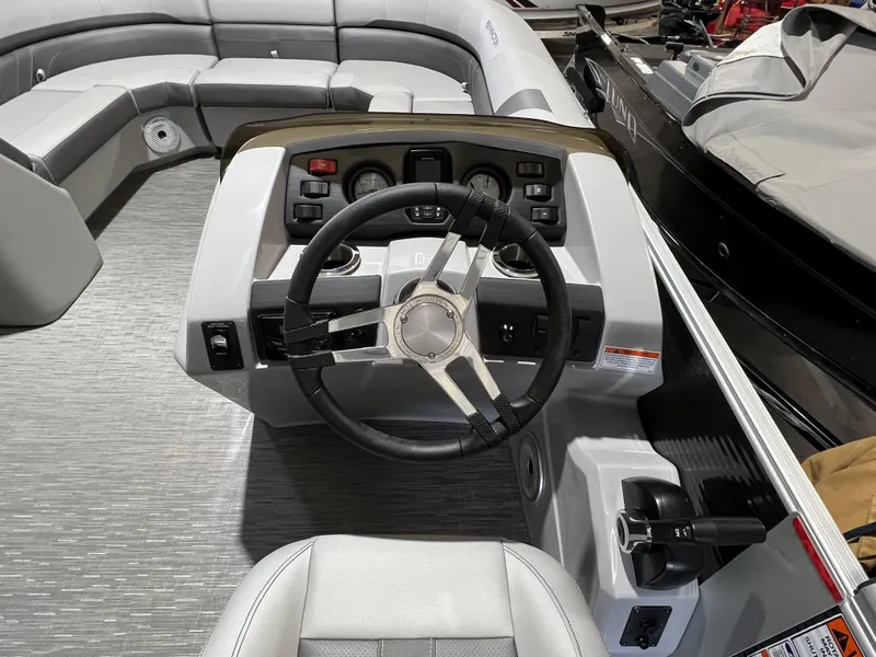 Slide: The Image of 2023 Bennington 22SXSB boat interior with steering wheel and seating area. - 7