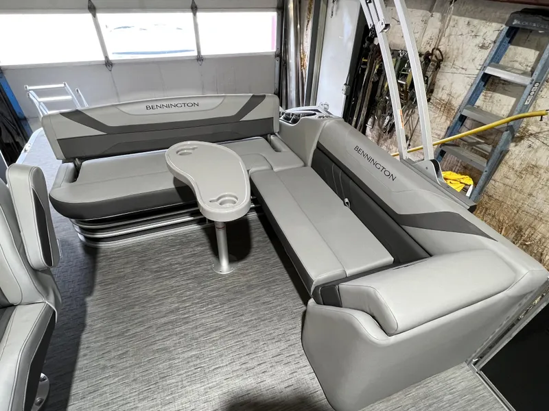 Slide: The Image of 2023 Bennington 22SXSB boat interior with gray seating and table. - 9