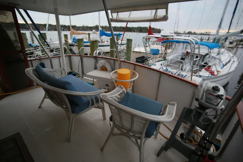 Slide: The Image of 1987 Jefferson 42 Sundeck Motor Yacht deck with seating, docked at marina. - 45