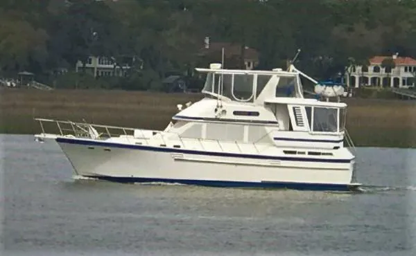 The Image of 1987 Jefferson 42 Sundeck Motor Yacht cruising on a calm waterway. - 0