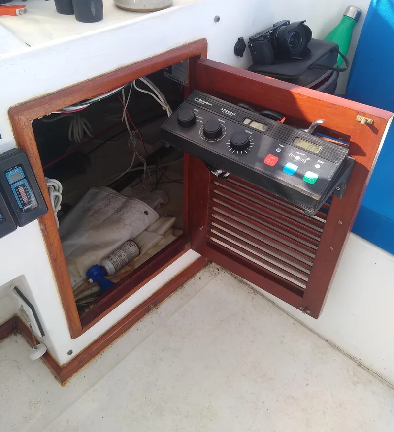 Slide: The Image of Control panel and storage compartment on a 1987 Jefferson 42 Sundeck Motor Yacht. - 11