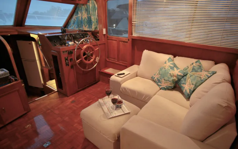 Slide: The Image of Interior of 1987 Jefferson 42 Sundeck Motor Yacht with cozy seating area. - 12