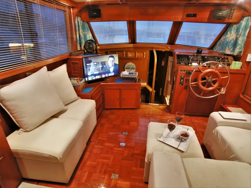 Slide: The Image of Interior of 1987 Jefferson 42 Sundeck Motor Yacht with cozy seating and entertainment system. - 13