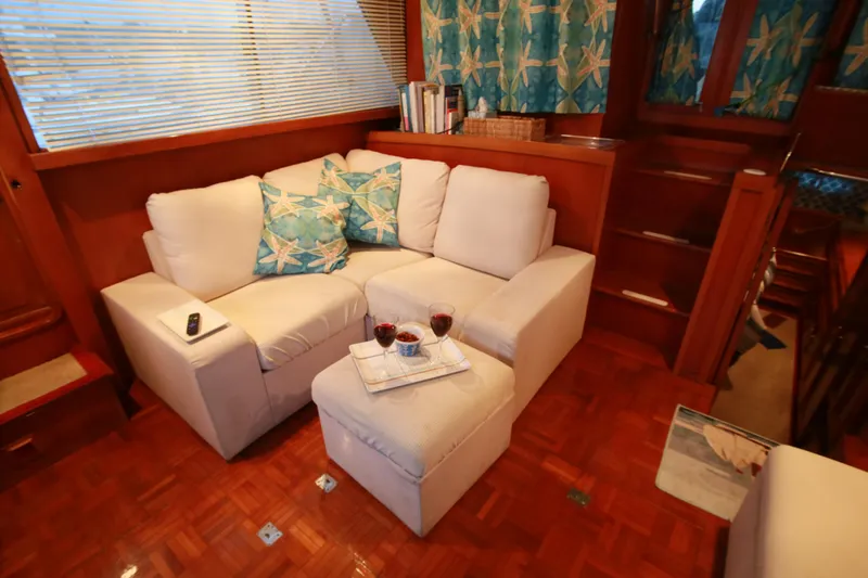 Slide: The Image of Cozy interior of 1987 Jefferson 42 Sundeck Motor Yacht with white sofa and wooden accents. - 14