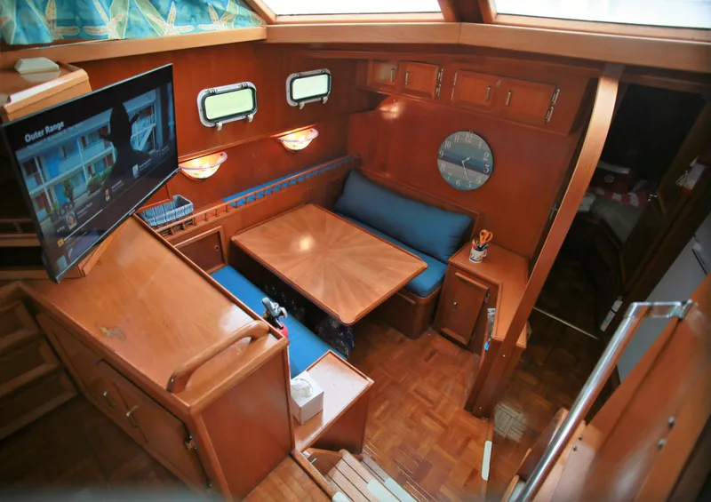 Slide: The Image of Interior of 1987 Jefferson 42 Sundeck Motor Yacht with dining area and TV. - 16