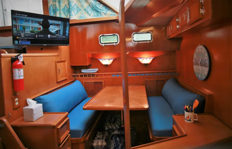 Slide: The Image of Interior of 1987 Jefferson 42 Sundeck Motor Yacht with cozy dining area and TV. - 18