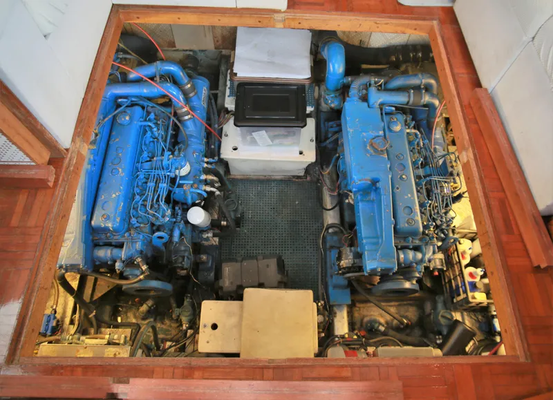 Slide: The Image of Engine room of a 1987 Jefferson 42 Sundeck Motor Yacht with twin blue engines. - 21