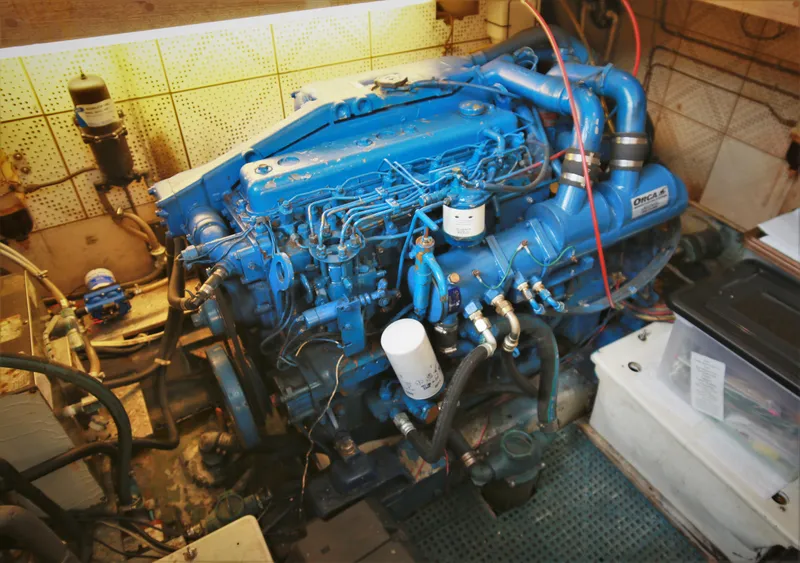 Slide: The Image of 1987 Jefferson 42 Sundeck Motor Yacht engine room with blue engine. - 23