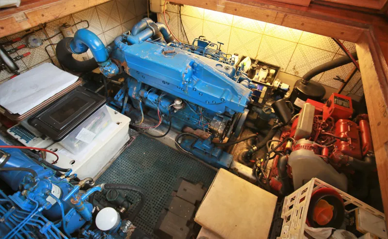 Slide: The Image of Engine room of a 1987 Jefferson 42 Sundeck Motor Yacht with blue machinery. - 24
