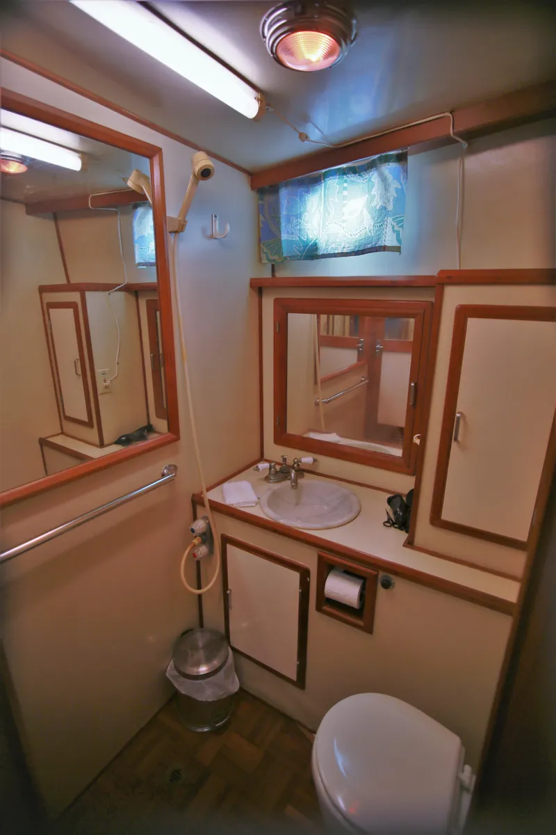 Slide: The Image of 1987 Jefferson 42 Sundeck Motor Yacht bathroom with sink, mirror, and storage cabinets. - 29