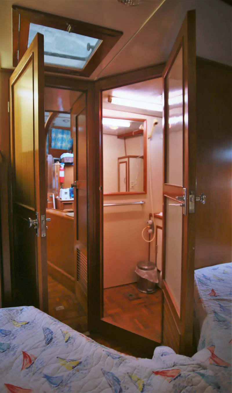 Slide: The Image of 1987 Jefferson 42 Sundeck Motor Yacht interior cabin with bathroom view. - 30