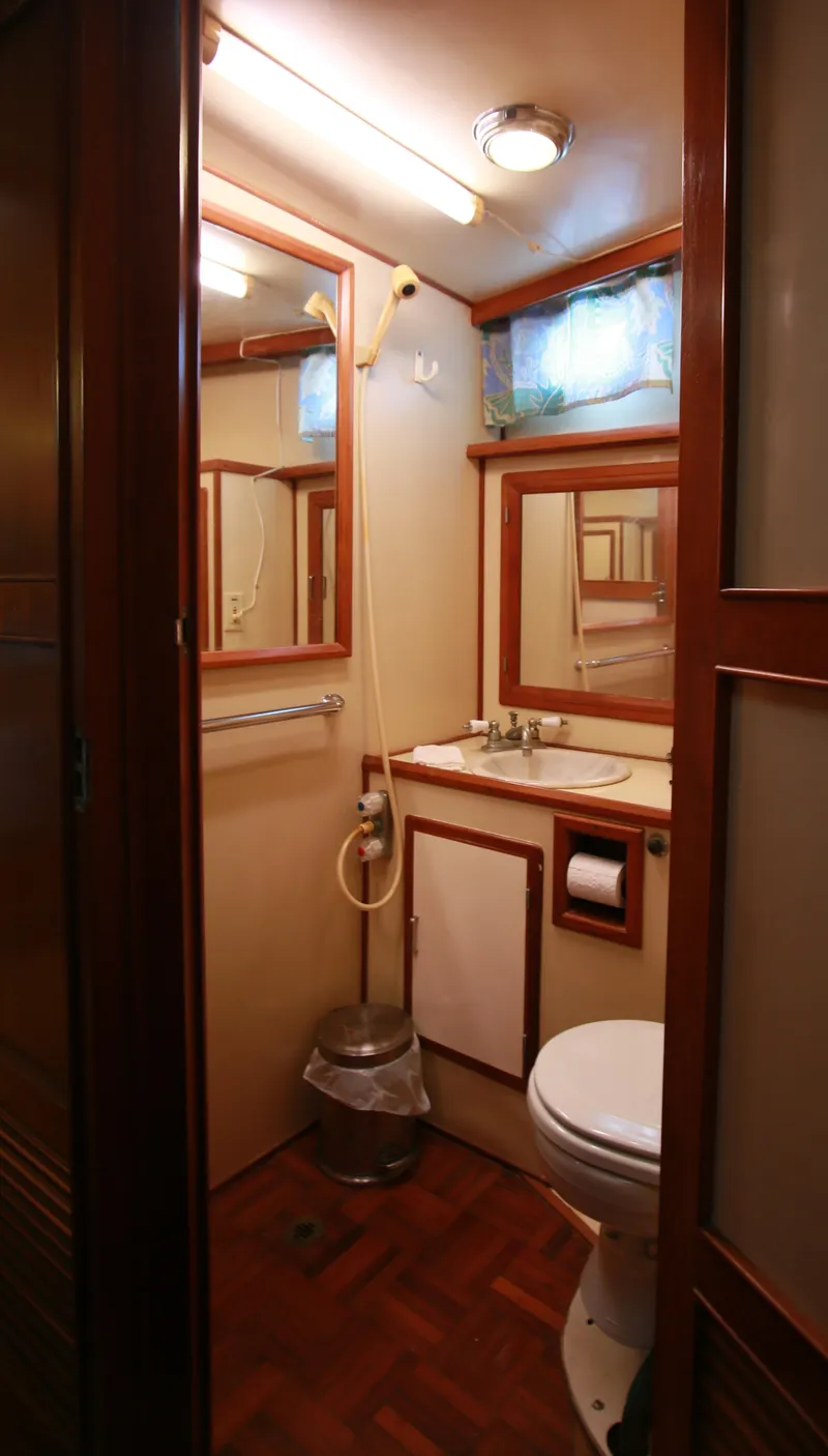 Slide: The Image of 1987 Jefferson 42 Sundeck Motor Yacht bathroom with wooden accents and compact design. - 31