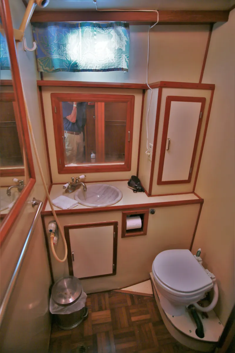 Slide: The Image of 1987 Jefferson 42 Sundeck Motor Yacht bathroom with sink, toilet, and storage cabinets. - 32