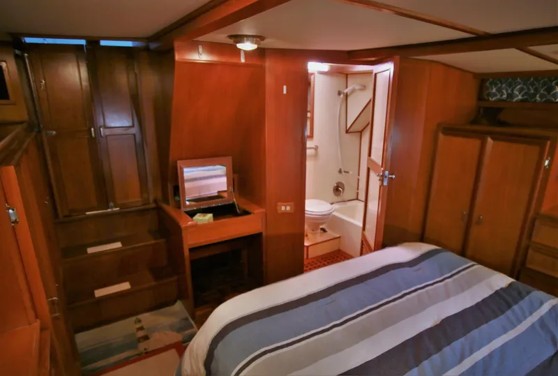 Slide: The Image of 1987 Jefferson 42 Sundeck Motor Yacht interior cabin with bed and en-suite bathroom. - 36