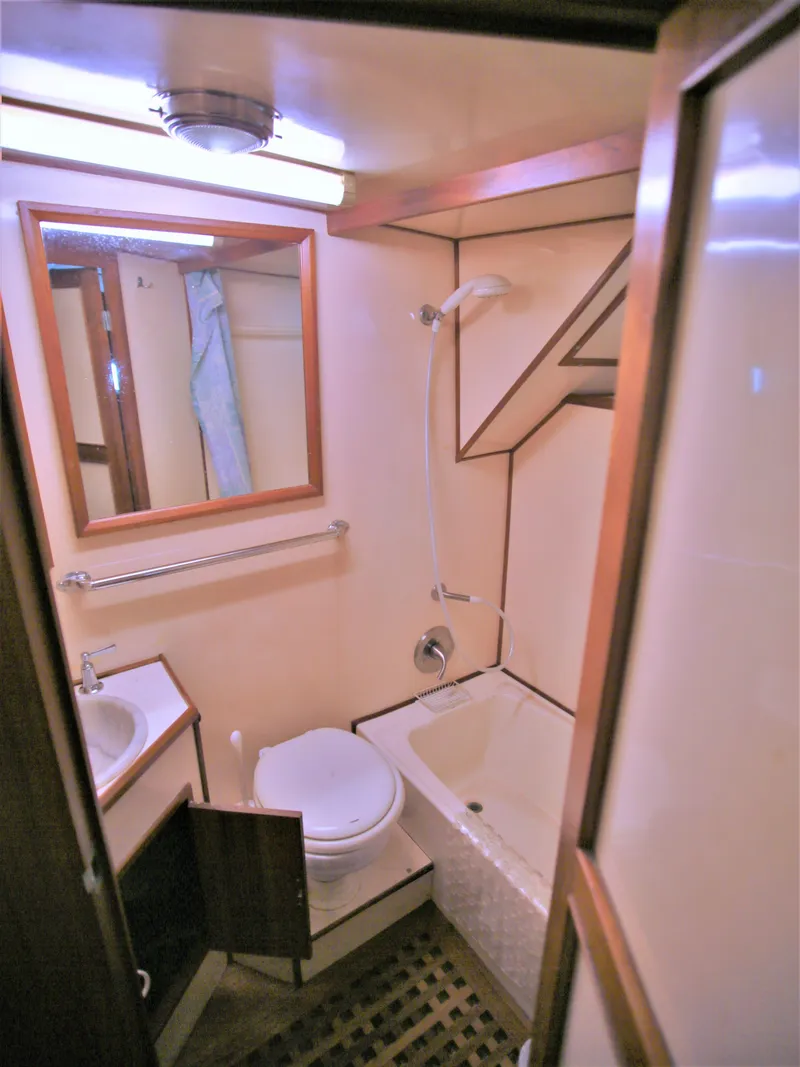 Slide: The Image of 1987 Jefferson 42 Sundeck Motor Yacht bathroom with sink, toilet, and shower. - 38
