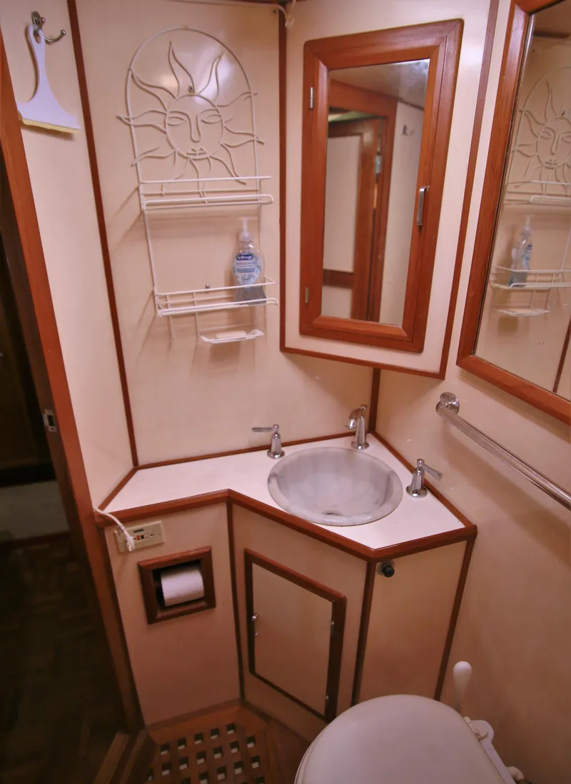 Slide: The Image of 1987 Jefferson 42 Sundeck Motor Yacht bathroom with sink, mirror, and storage. - 40